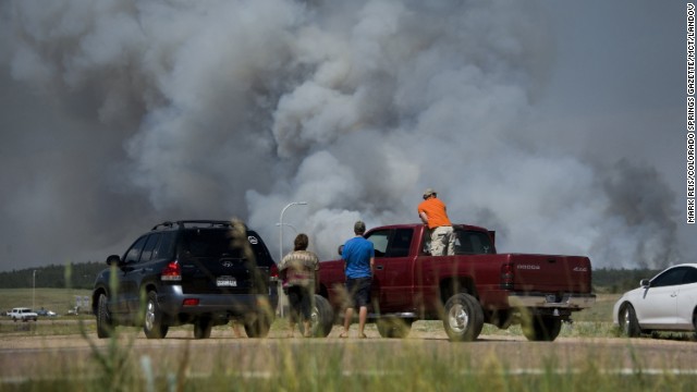 Motorists stop along Interquest Parkway in Colorado Springs on June 11 to watch the advance of a wildfire burning in the Black Forest.