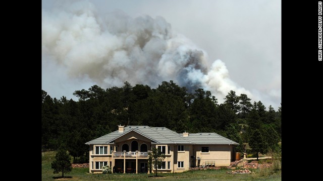 Smoke billows from the Black Forest Fire near a house north of Colorado Springs on June 12.