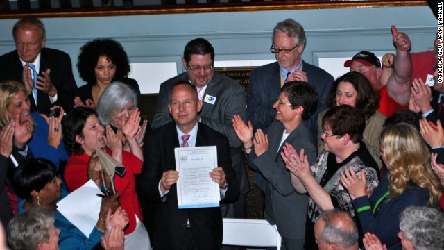 Delaware Gov. Jack Markell holds up legislation in May 2013 allowing same-sex couples to wed in the state.