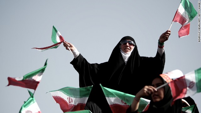 Supporters of top nuclear negotiator and conservative presidential candidate Saeed Jalili wave national flags during his campaign rally at Heydarnia stadium in Tehran on Wednesday, June 12.