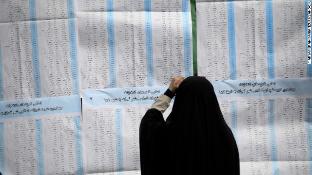 A woman checks out her ballot before voting in Iran's presidential elections at a Tehran polling station on June 14. 