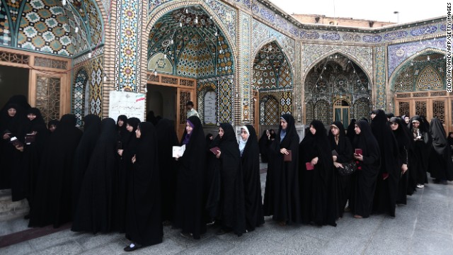 Women wait in line to vote at a shrine in Qom on June 14.