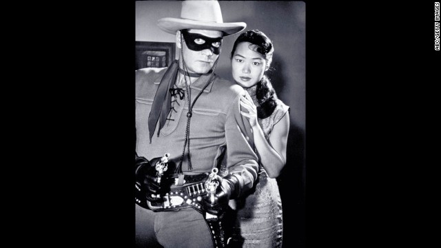 Moore, as the Lone Ranger, protects a lady in distress.