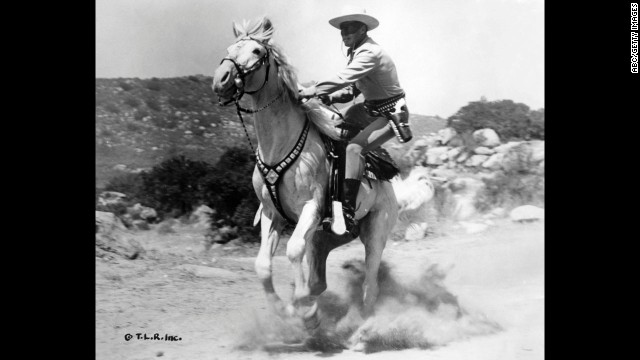 Moore dismounts from a gallop while playing the Lone Ranger.