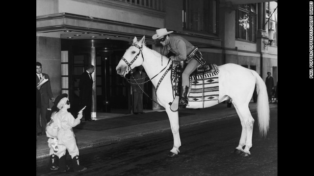 Outside the Savoy Hotel in London, two small boys hold up the Lone Ranger on July 21, 1958. Clayton Moore was in London for a four-week promotional tour, and the boys were members of the Lone Ranger Club.