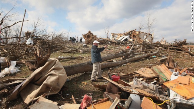 Insurance adjuster Mark Ricketts photographs a home destroyed by a tornado in Henryville, Indiana, on March 4, 2012. Tornadoes and severe weather that struck the Ohio valley and southeast on March 2 and March 3 caused about $3.1 billion in losses.