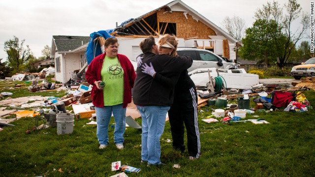 Two women embrace while surveying the damage left in the wake of a tornado that hit Creston, Iowa, on April 15, 2012. An outbreak of tornadoes in the Midwest on April 13 and April 14 caused about $1.1 billion in losses.