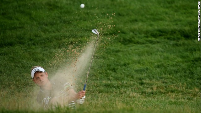 Luke Donald hits a shot from a bunker on the 17th hole during round three on June 15. 