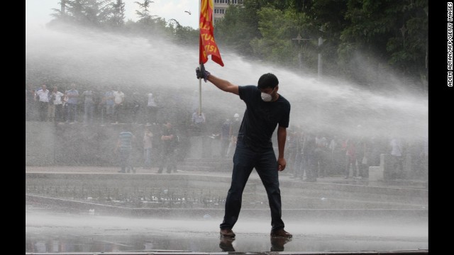 A protester faces water cannons during a clash with police at an anti-government demonstration in Ankara on June 16. 