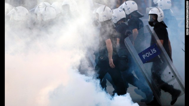 Police walk through tear gas during protests at Kizilay Square in central Ankara on June 16.