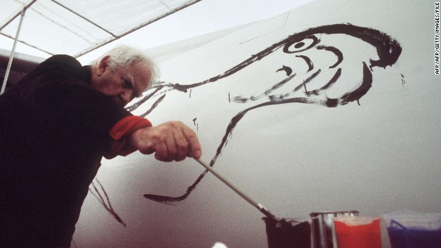 U.S. painter and sculptor Alexander Calder, credited as the creator of hanging wire mobiles, paints a bird on a fuselage of a Braniff jetliner on May 29, 1975 at the Paris Airshow. 