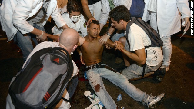 A protester receives assistance after being shot in the leg in Rio de Janeiro on June 17.