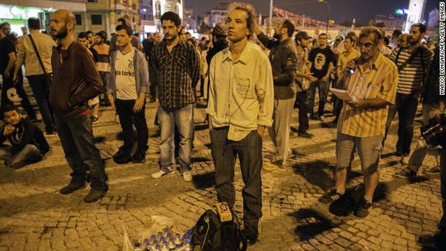 Turkish performance artist Erdem Gunduz, center, is joined by others as he makes his silent protest in Taksim Square. As word of his gesture of protest spread, Gunduz became known as the "standing man." Protests that began as a demonstration against the planned demolition of a park have grown into general anti-government dissent across the nation. 