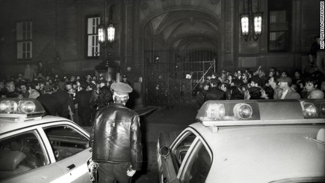 Crowds gather outside of the Central Park West apartment building, the Dakota, after news of Lennon's death. 