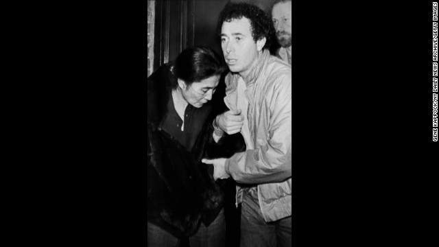 Yoko Ono is helped by David Geffen as she leaves Roosevelt Hospital after learning of the death of her husband.