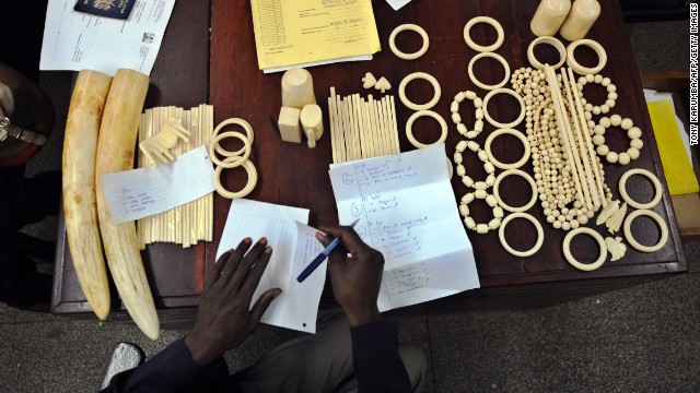 A police officer catalogs illegal ivory found in the possession of four Chinese men in Nairobi, Kenya, in January. The men pleaded guilty to smuggling thousands of dollars worth of ivory and were fined just $340 each. The loot included 40 chopsticks, six necklaces, bracelets and a pen holder, as well as raw ivory that had a black market value of $24,000 in Asia. 