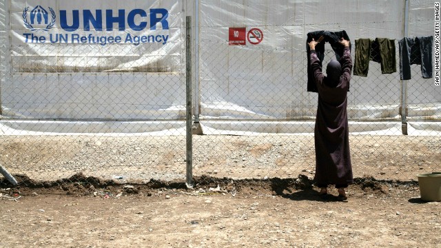 A woman uses a fence at the Domiz refugee camp near Kohuk, Iraq, to dry laundry on May 29.