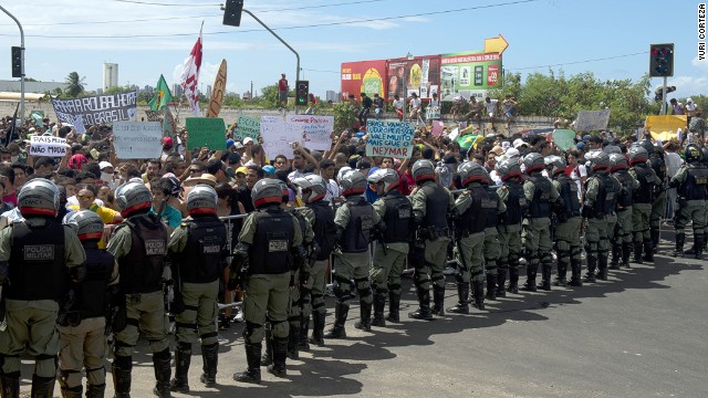 Protesters confront riot police officers on the distant outskirts of the Castelao Stadium, which has been newly built for next year's World Cup at a cost of $240 million.