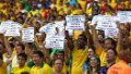 Brazil fans hold up banners protesting against social conditions prior to their Confederations Cup between against Mexico.