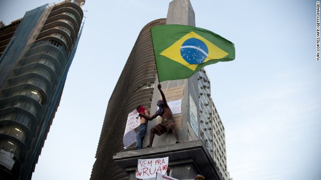 A demonstrator waves the Brazilian flag during the 2013 protests in Belo Horizonte, where thousands marched.<!-- -->
</br><!-- -->
</br> 