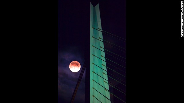 The moon hangs in the sky over Rotterdam, the Netherlands, on June 22. Share your Supermoon stories.