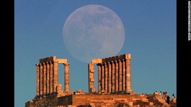 The Supermoon rises over the temple of Poseidon, the ancient Greek god of the seas, as the sun sets on Cape Sounion outside Athens, Greece, on June 22. 