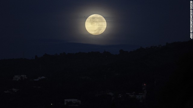 The moon lights the sky over San Salvador, the capital of El Salvador, on June 23.