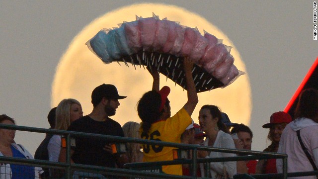 A cotton candy vendor weaves through the crowd during the Los Angeles Angels' baseball game against the Pittsburgh Pirates on Saturday, June 22.