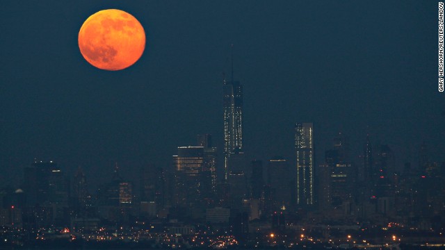 The moon hangs over the Manhattan skyline on June 23.