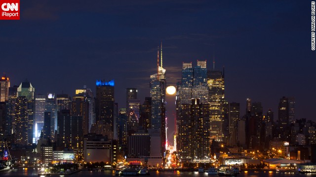 <a href='http://ireport.cnn.com/docs/DOC-994273'>Marlon Flores</a> photographed the supermoon from Weehawken, New Jersey, while it appeared to be wedged between Manhattan buildings. The aspiring astronomer says the more he photographs the moon and stars, "the more I'm into it."