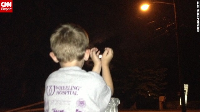 <a href='http://ireport.cnn.com/docs/DOC-994146'>Jennifer Uhrig </a>photographed her son, Hayden, capturing the supermoon outside their home in Wheeling, West Virginia. As a science fan, Hayden talked about the supermoon all weekend, and later in the evening the pair went outside to reach for the moon. "Ten-thirty is pretty late for us, so it really turned into a giggle session as we tried to get the right shots," Uhrig said.