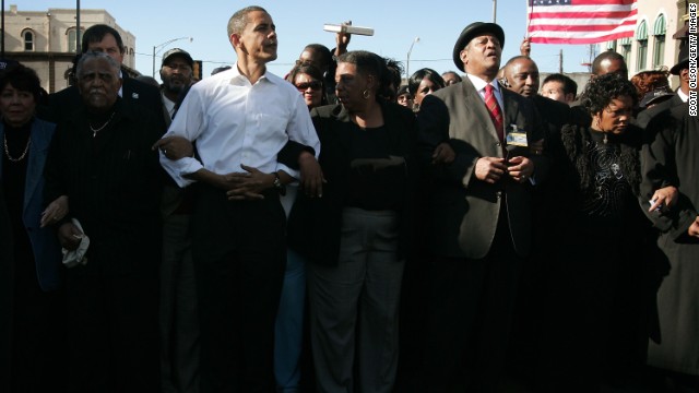 President Barack Obama marches with civil right veterans during a commemoration march in 2007.