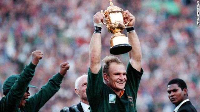 Mandela, left, cheers as Springbok Rugby captain Francois Pienaar holds the Webb Ellis trophy high after winning the World Cup Rugby Championship in Johannesburg on June 24, 1995. 