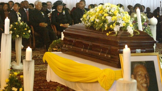 Mandela sits with his wife, Graca Machel, and his grandchildren at his son's funeral on January 15, 2005. He disclosed that his son, Makgatho Lewanika Mandela, had died of AIDS and said the disease should be given publicity so people would stop viewing it as extraordinary.