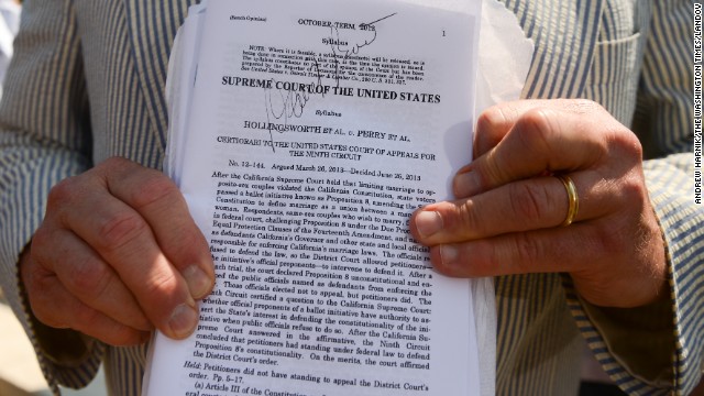 Erin Raskauskas Jr. shows off the autograph he got from attorney David Boies on a copy of the Proposition 8 ruling outside of the Supreme Court in Washington.