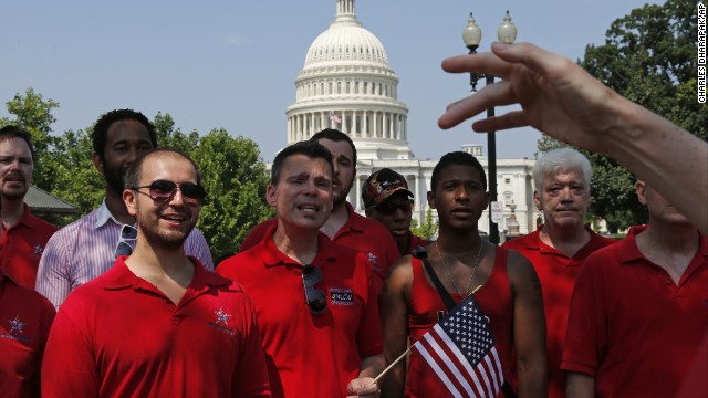 With the Capitol in the background, the Gay Men's Choir of Washington performs outside of the Supreme Court in Washington.