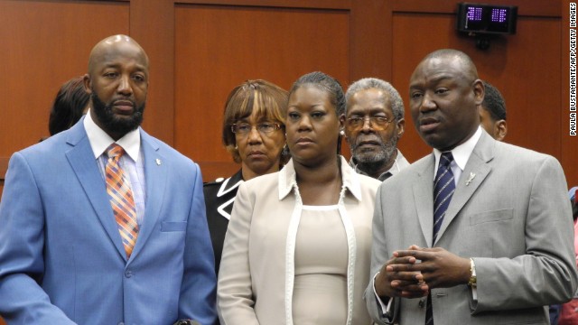 From left, Martin's parents, Tracy Martin and Sybrina Fulton, and Benjamin Crump, the family's legal counsel, make a brief statement to the media before jurors heard opening statements on June 24.