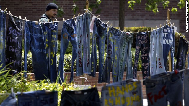 A man looks at blue jeans with messages challenging misconceptions about sexual violence at the University of California Los Angeles on April 21, 2004. Since 1999, wearing jeans on Denim Day became a symbol of protest in response to an Italian Supreme Court decision that overturned a rape conviction because, the justices reasoned, the victim wore tight jeans and must have helped her attacker remove her pants.