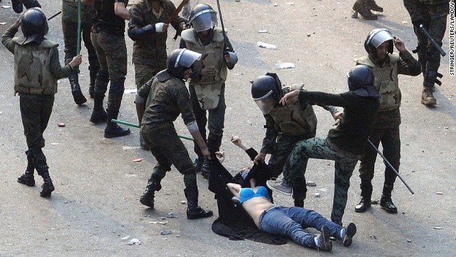 Egyptian army soldiers beat a young woman during a protest at Tahrir Square in Cairo on December 17, 2011. The shocking image of the "blue bra girl" <a href='http://www.cnn.com/2011/12/22/opinion/coleman-women-egypt-protest/index.html'>became a symbol of the oppression </a>and a rallying cry for several thousand Egyptian women.