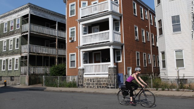 A lone cyclist rides by the apartment building where Renata lives in Boston.