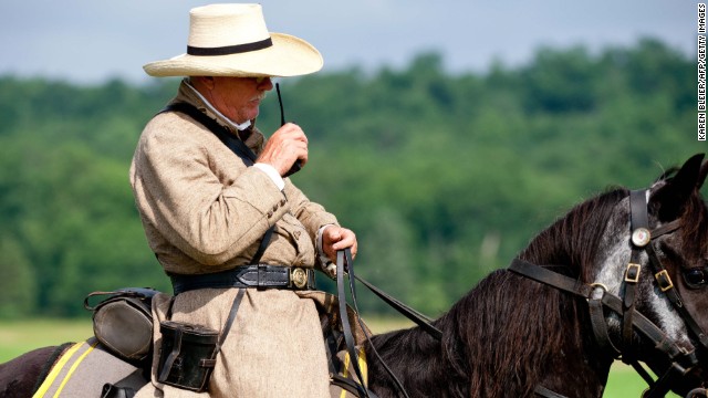 In a rare concession to non-period technology, a Confederate officer speaks into his walkie-talkie to position his troops during a reenactment.