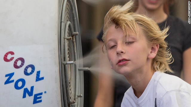 Easton Martin, 10, stops to cool off in a misting fan while walking along the Las Vegas Strip with his family on Friday, June 28. Triple-digit temperatures have stifled the Southwest and aren't expected to relent until Tuesday.