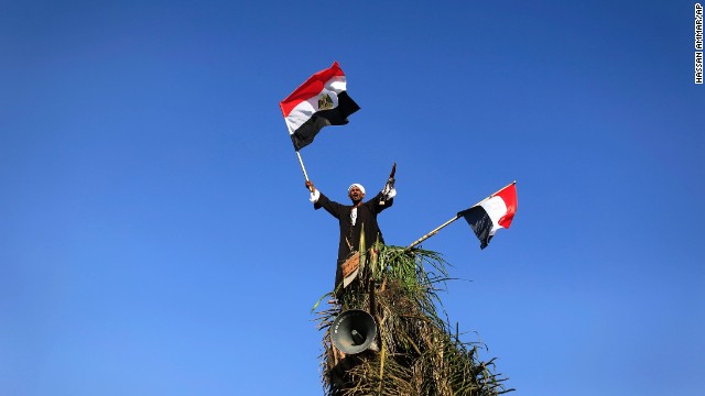 A Morsy opponent waves Egyptian flags during a protest outside the Egyptian Defense Ministry in Cairo on June 28.