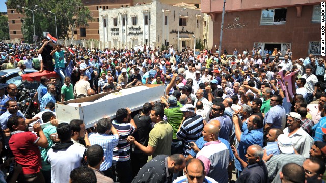 Mourners carry the coffin of journalist Salah Hassan during his funeral in Port Said on June 29. He died in the recent unrest.