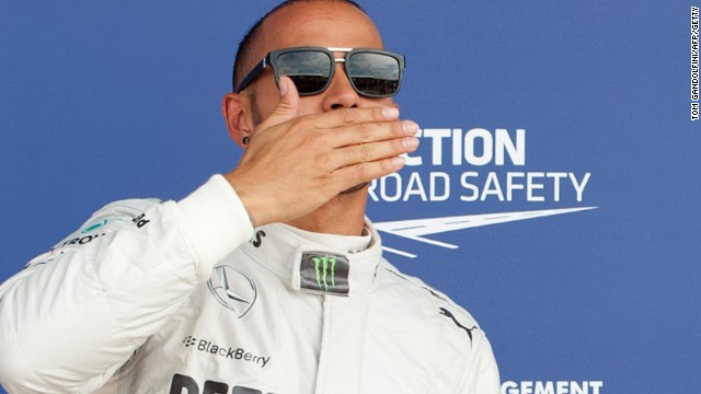 Sealed with a kiss. Lewis Hamilton celebrates his pole position in the British Grand Prix at Silverstone