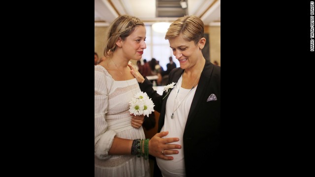 Stefanie Berks, left, touches her pregnant partner, Daisy Boyd, before their marriage at the Manhattan Marriage Bureau in New York on June 28.