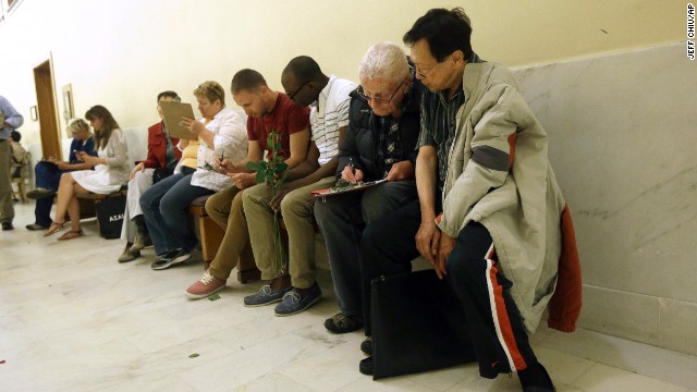 Couples fill out license applications as they wait in line at the San Francisco City Hall on June 28.