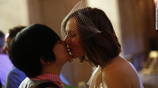 Ky Choi, left, and Ashlee Meyer kiss before getting married on June 29.