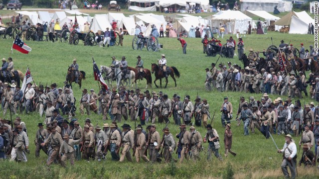 Confederate Civil War reenactors march towards Union positions during Pickett's Charge on June 30.