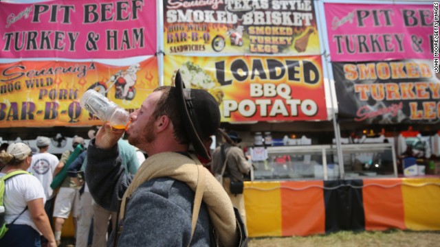 A Confederate Civil War reenactor drinks a sports drink while taking a break from the event on June 30. 